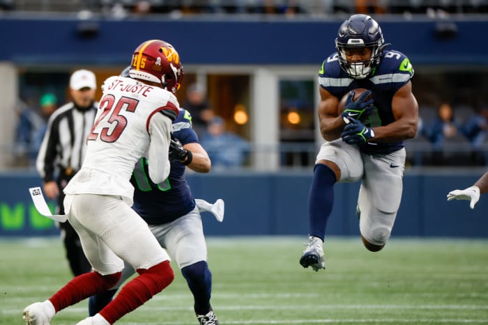 Seattle Seahawks running back Kenneth Walker III (9) rushes against the Washington Commanders during the second quarter at Lumen Field.